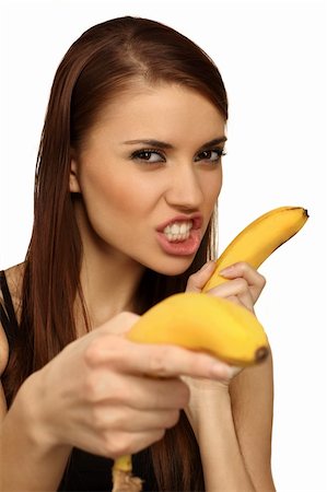 pretty women eating banana - The woman holds bananas on a head Photographie de stock - Aubaine LD & Abonnement, Code: 400-04673239