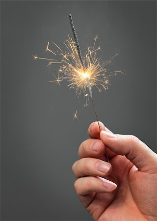 Hand holding a sparkler firework Foto de stock - Super Valor sin royalties y Suscripción, Código: 400-04673291