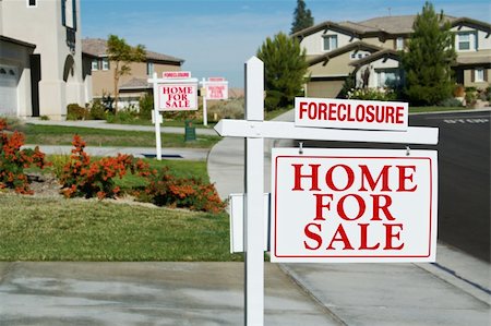 simsearch:400-04478863,k - Row of Foreclosure Home For Sale Real Estate Signs in Front of Houses. Stock Photo - Budget Royalty-Free & Subscription, Code: 400-04684759