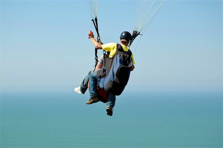 Double Paragliding flying through the sky above the ocean Stock Photo - Budget Royalty-Free & Subscription, Code: 400-04685372