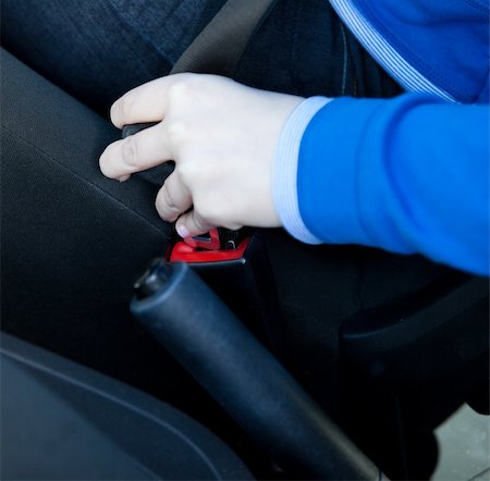 Close-up of woman putting seat belt in her car Stock Photo - Budget Royalty-Free & Subscription, Code: 400-04686880