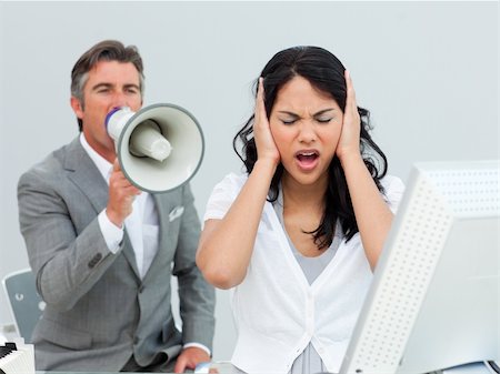 scream computer mad - Furious manager shouting through a megaphone in a colleague's ears in the office Stock Photo - Budget Royalty-Free & Subscription, Code: 400-04687331