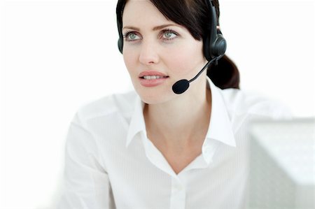 simsearch:400-03912315,k - Serious businesswoman with headset on working at a computer Photographie de stock - Aubaine LD & Abonnement, Code: 400-04687365