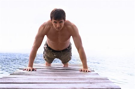 Man is pushing up at light background Stockbilder - Microstock & Abonnement, Bildnummer: 400-04687534