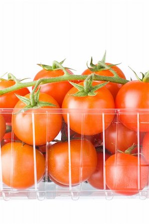 branch of cherry tomatoes in plastic container.white background Foto de stock - Royalty-Free Super Valor e Assinatura, Número: 400-04688966