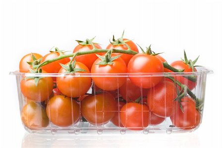 cherry tomatoes on  a branch in plastic container Foto de stock - Royalty-Free Super Valor e Assinatura, Número: 400-04688968