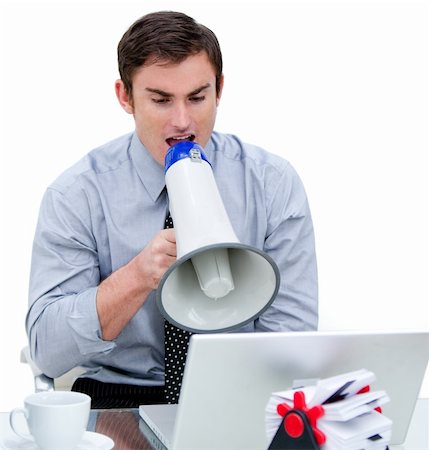 simsearch:400-04126489,k - Angry businessman yelling through a megaphone sitting at his desk in the office Stock Photo - Budget Royalty-Free & Subscription, Code: 400-04689175