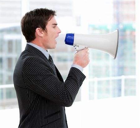 simsearch:400-04126489,k - Frustrated businessman yelling through a megaphone standing in the office Stock Photo - Budget Royalty-Free & Subscription, Code: 400-04689178