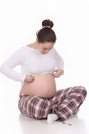 simsearch:400-04582878,k - pregnant woman looking belly on white background Foto de stock - Super Valor sin royalties y Suscripción, Código: 400-04680080