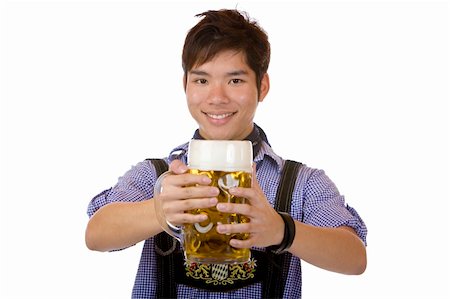 simsearch:400-07124078,k - Asian man holding an Oktoberfest beer stein into camera and smiles happy. Isolated on white. Stockbilder - Microstock & Abonnement, Bildnummer: 400-04680528