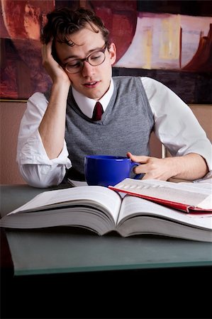 stress coffee - Tired student drinks coffee whilst studying Stock Photo - Budget Royalty-Free & Subscription, Code: 400-04680876