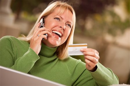 simsearch:673-03623074,k - Cheerful Woman on Her Phone and Laptop with Credit Card. Photographie de stock - Aubaine LD & Abonnement, Code: 400-04681019