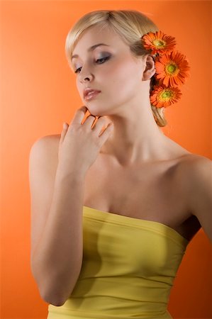 simsearch:400-04863868,k - young beauty blond girl on orange background with yellow top and some gerbera flowers on her head Stock Photo - Budget Royalty-Free & Subscription, Code: 400-04681152