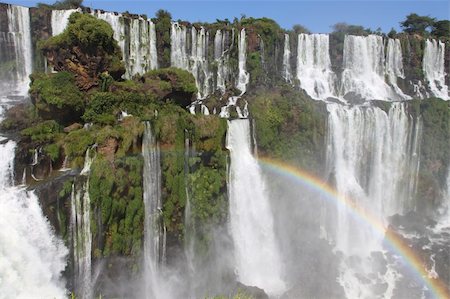 Iguazu waterfalls with rainbow on a sunny day. The largest waterfall on earth Stockbilder - Microstock & Abonnement, Bildnummer: 400-04681182