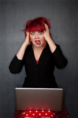simsearch:400-04681336,k - Pretty punky girl with brightly dyed red hair with laptop computer Stock Photo - Budget Royalty-Free & Subscription, Code: 400-04681315