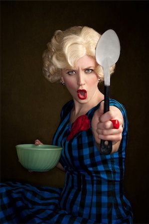 Pretty retro blonde woman in vintage 50s dress with bowl and spoon Stock Photo - Budget Royalty-Free & Subscription, Code: 400-04681355