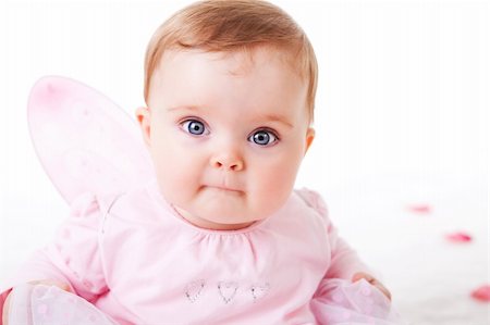 simsearch:400-04436228,k - A cute baby girl wearing fairy wings stares wide-eyed at the camera.  Horizontal shot. Stock Photo - Budget Royalty-Free & Subscription, Code: 400-04694255