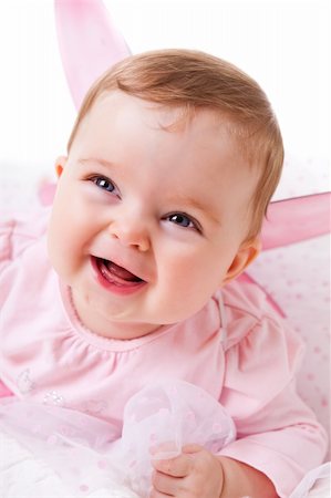 simsearch:400-04436228,k - A cute baby girl in fairy wings laughs while looking up at the camera.  Vertical shot. Stock Photo - Budget Royalty-Free & Subscription, Code: 400-04694253