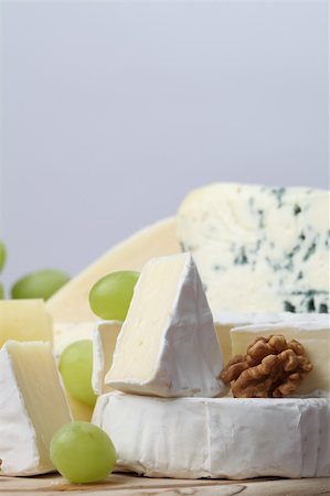 emmentaler cheese - Various kinds of cheese with walnuts and grapes Stock Photo - Budget Royalty-Free & Subscription, Code: 400-04694365