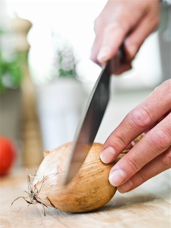 spanish onion - Human cutting onion in the kitchen Stock Photo - Budget Royalty-Free & Subscription, Code: 400-04695049