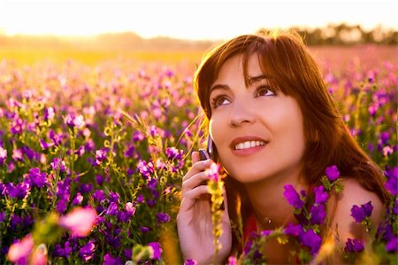 Beautiful young woman lying on the nature and talking at cellphone Stock Photo - Budget Royalty-Free & Subscription, Code: 400-04695345