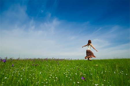 Young woman dancing on a beautiful green meadow Stock Photo - Budget Royalty-Free & Subscription, Code: 400-04695357