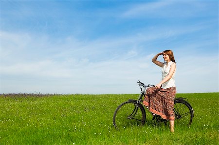 simsearch:400-04201795,k - Happy young woman with a vintage bicycle on a green meadow Stock Photo - Budget Royalty-Free & Subscription, Code: 400-04695352