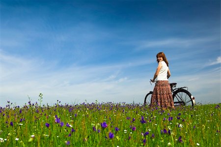 simsearch:400-04201795,k - Happy young woman with a vintage bicycle on a green meadow Stock Photo - Budget Royalty-Free & Subscription, Code: 400-04695353