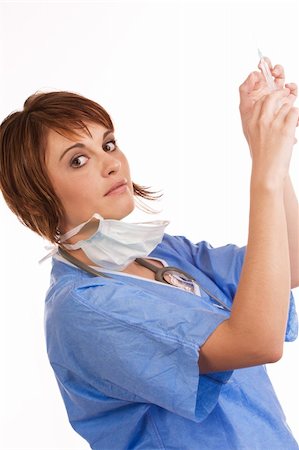 Young female Caucasian doctor holding up a filled syringe, looking at you Foto de stock - Super Valor sin royalties y Suscripción, Código: 400-04696595