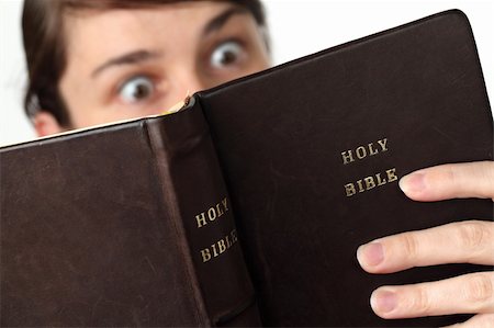 simsearch:400-04719774,k - Young woman reading the Bible with surprised look Photographie de stock - Aubaine LD & Abonnement, Code: 400-04697118