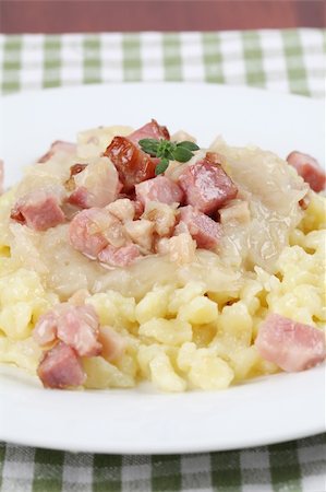 Slovak national food called "halusky" - small potato dumplings (gnocchi) with sauerkraut and smoked meat Stock Photo - Budget Royalty-Free & Subscription, Code: 400-04697140