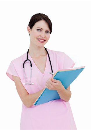 Charming female nurse writing on a clipboard isolated on a white background Stock Photo - Budget Royalty-Free & Subscription, Code: 400-04697249