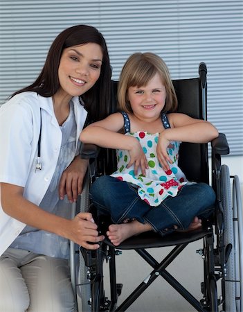 Cute girl sitting on a wheelchair with a female doctor in the hospital Foto de stock - Super Valor sin royalties y Suscripción, Código: 400-04697265