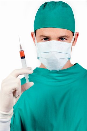 Confident surgeon holding a syringe against a white background Stock Photo - Budget Royalty-Free & Subscription, Code: 400-04697297