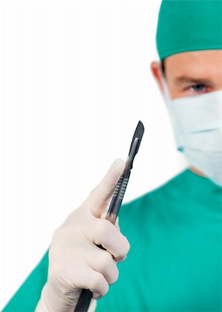 simsearch:400-05192324,k - Assertive male surgeon holding a scalpel isolated on a white background Stock Photo - Budget Royalty-Free & Subscription, Code: 400-04697300
