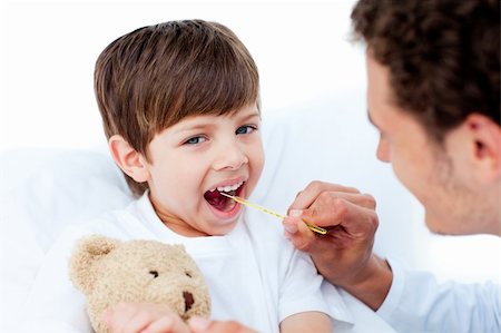 sick boy with teddy - Young doctor taking little boy's temperature at the hospital Stock Photo - Budget Royalty-Free & Subscription, Code: 400-04697310
