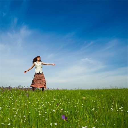 Young woman dancing on a beautiful green meadow Stock Photo - Budget Royalty-Free & Subscription, Code: 400-04697442