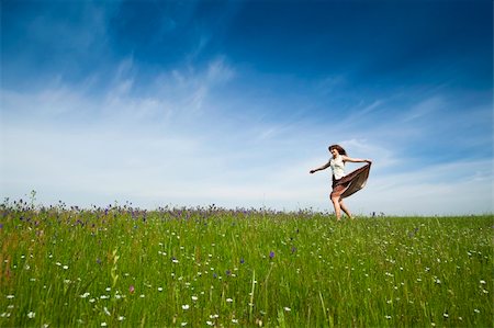 Young woman dancing on a beautiful green meadow Stock Photo - Budget Royalty-Free & Subscription, Code: 400-04697443