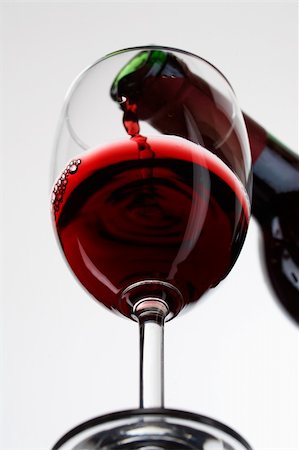 pouring alcohol moving picture - Red wine pour in a glass on white background Stock Photo - Budget Royalty-Free & Subscription, Code: 400-04697566