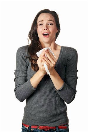 An attractive woman with hay fever or a cold sneezing into tissue Stock Photo - Budget Royalty-Free & Subscription, Code: 400-04697946