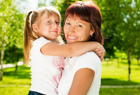 simsearch:400-05248187,k - happy young mother in park with her beautiful small daughter, both smiling and looking in camera Photographie de stock - Aubaine LD & Abonnement, Code: 400-04698485