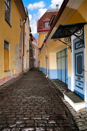rain on roof - narrow cosy street in center of old european town. Blue cloudy sky in background. Tallin, Estonia, Europe. Stock Photo - Budget Royalty-Free & Subscription, Code: 400-04698491
