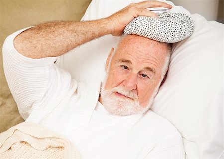 Senior man home sick with a cold, flu, or hangover. Stock Photo - Budget Royalty-Free & Subscription, Code: 400-04699557