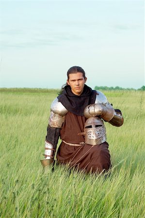 Medieval knight in the field with an helmet Stock Photo - Budget Royalty-Free & Subscription, Code: 400-04699960