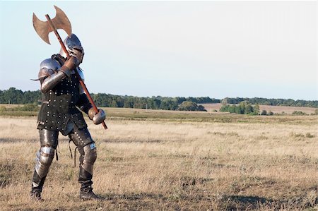 Medieval knight in the field with an axe Photographie de stock - Aubaine LD & Abonnement, Code: 400-04699973
