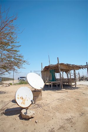 Rural communication through satellite dishes outside a dilapidated old dwelling Stock Photo - Budget Royalty-Free & Subscription, Code: 400-04690124