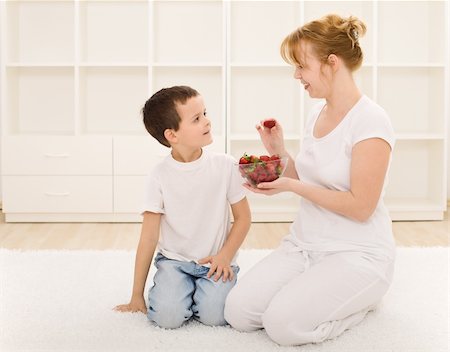 simsearch:400-06177351,k - Happy healthy boy and woman eating fresh strawberries Stock Photo - Budget Royalty-Free & Subscription, Code: 400-04690505