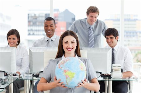 Brunette businesswoman and her team showing a terrestrial globe in the office Stock Photo - Budget Royalty-Free & Subscription, Code: 400-04690620