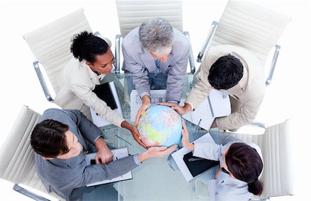 Serious international business team holding a terrestrial globe in a meeting Photographie de stock - Aubaine LD & Abonnement, Code: 400-04690842