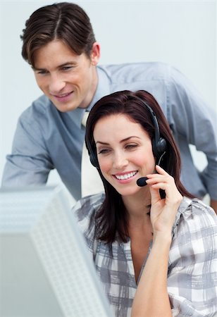 simsearch:400-04188205,k - Smiling businessman helping his colleague at a computer Stock Photo - Budget Royalty-Free & Subscription, Code: 400-04690906